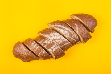 Sliced bread for dinner on a yellow background - minimalism