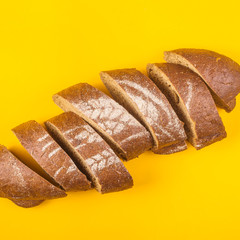 Sliced bread for dinner on a yellow background - minimalism