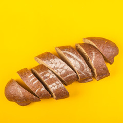 Sliced bread for dinner on a yellow background - minimalism
