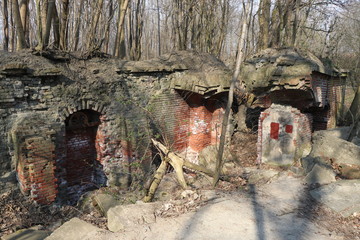 ruins of a blown up fortress with a sign with a destroyed walls