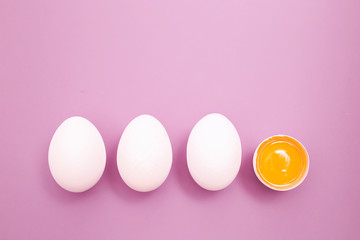 Chicken white eggs with raw broken yellow yolk. 