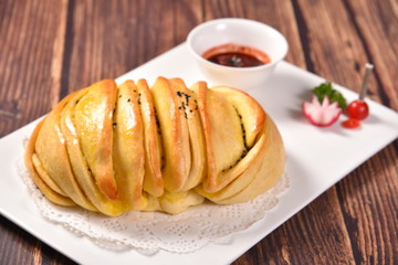 croissant with jam and cup of coffee on wooden table