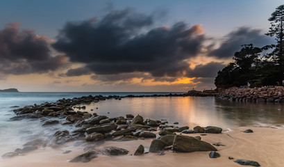 Low Clouds and Sunrise at the Rock Pool Seaside