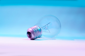 Fototapeta na wymiar Light bulb. Clear and clean bulb, isolated on nuances of blue and white, symbolizes energy technology.
