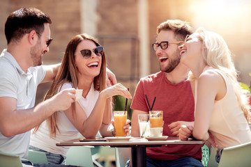 Group of friends have fun in cafe