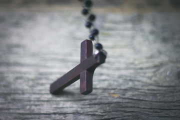 wooden cross on wooden table