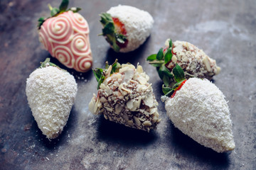 Strawberries covered with chocolate on the rustic background. Selective focus. Shallow depth of field.