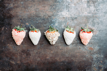Strawberries covered with chocolate on the rustic background. Selective focus. Shallow depth of field.