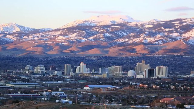 Reno Nevada time lapse of sun rising across mountains and city golden hour