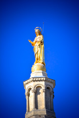Statue on the top of the Palace of the Popes, Avignon (France) - historical palace located in Avignon, Southern France