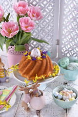 easter festive table with traditional ring cake and tulips