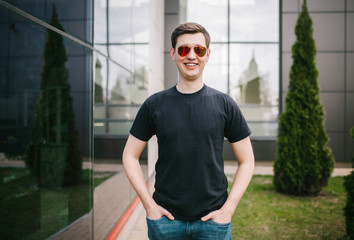 A stylish man in a black T-shirt. Street photo