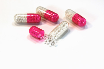 medical capsules with granules on a white background.
