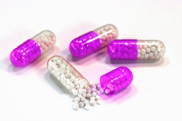 medical capsules with granules on a white background.