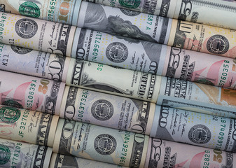 Background of the different American dollar bills in rolls.