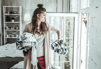 Angry woman throwing the shirts of her ex away