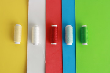 sewing threads on colorful background