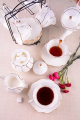 cup of coffee and flowers on table