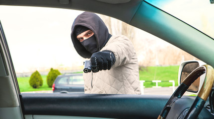 a thief with a gun threatens the driver