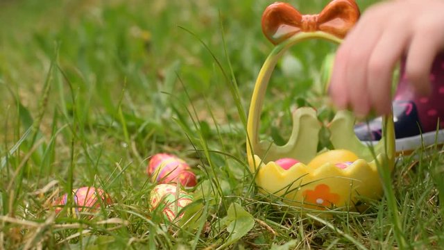 Video HD with child hunting easter eggs in grass 