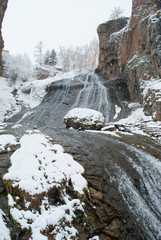 Fototapeta na wymiar mountains under the snow, waterfall, landscape with red rocks