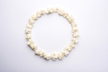 Jasminum sambac or Mogra Flower arranged in a  circular or rectangular  frame shape over white background, selective focus