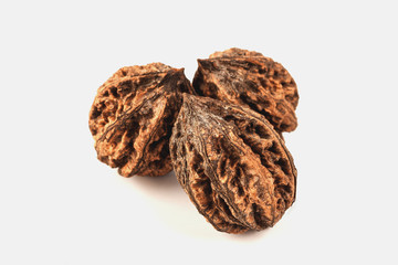 three big wild walnuts on white background