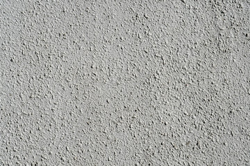 Plain gray textured plastered wall. Rough textured background of wall with copy space for text