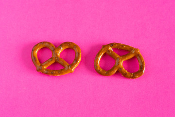 fresh baked pretzel cookies on pink background close-up top view