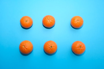 fresh tangerines isolated on blue background