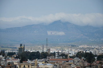 Obraz premium Turkish part of the Nicosia. Turkish flag on mountain in Nicosia, Cyprus, Lefkosia