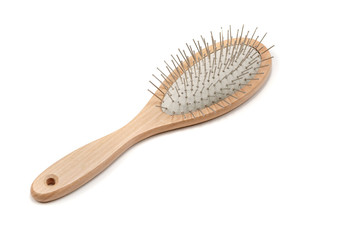 Wooden hair brush on white background. Studio shot.