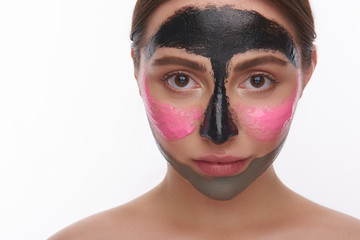 Woman with face mask looking at the camera on the white background