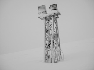 Frozen light mast  on the snow slope of mountain in Khibiny at the coldest winter time