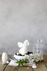 Table setting for happy Easter in rustic style.