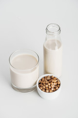 chickpea in bowl near vegan chickpea milk on grey background