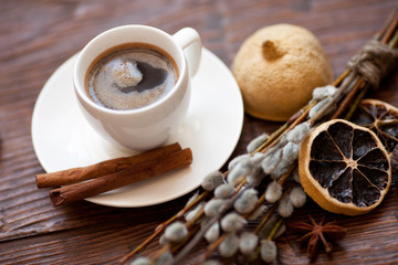 Coffee cup and willow branches, dry lemon, cinnamon.