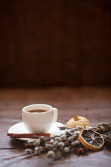 Coffee cup and willow branches, dry lemon, cinnamon.
