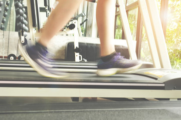 woman running on treadmill in gym