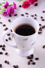 cup of coffee and beans on white background