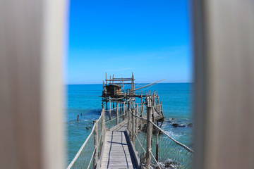 Panoramic view of an Ancient fishing machine called "Trabucco" = "trebuchet", typical of the Italian Adriatic coast, Puglia and Gargano, Molise and Abruzzo, protected as a monumental heritage.