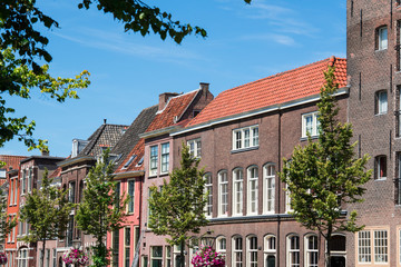 Fototapeta na wymiar row houses against blue sky in street Oude Rijn in Leiden, The Netherlands