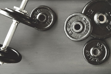 Obraz premium dumbbell and barbell on floor at gym