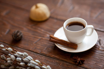 Coffee cup and willow branches, dry lemon, cinnamon.