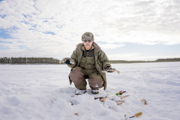 Fototapeta na wymiar fisherman catch on winter fishing