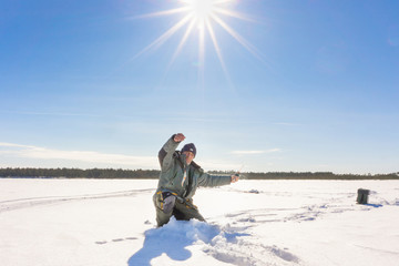 Fototapeta na wymiar fisherman catch on winter fishing