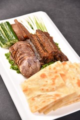 grilled steak with vegetables on white plate