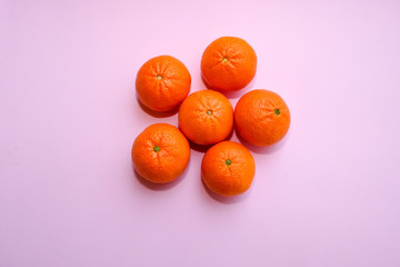 fresh tangerines isolated on pink background, top view