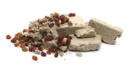 Halvah with raisins and peanuts isolated on white background