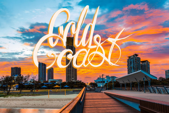 Gold Coast lettering on photograph of beautiful vivid orange sunset in Queensland, Australia